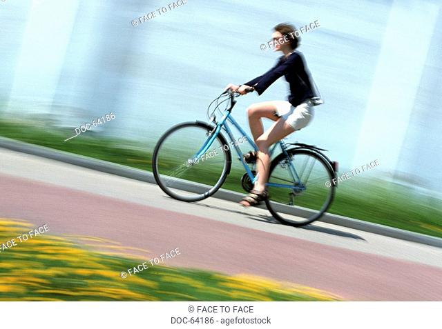woman goes by bike onto street