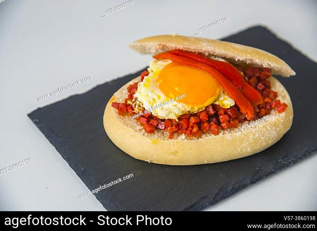Tapa made of picadillo, fried egg and red pepper in bread. Spain