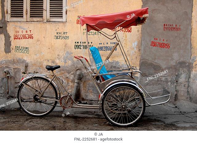 Rickshaw parked at roadside, Hanoi, Vietnam