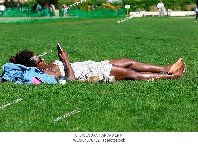People enjoy the warm weather in London. Heatwave in London and South East as temperatures are likely to reach 28 degrees celsius and will be the hottest April...