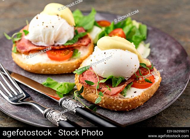 Delicious breakfast with eggs Benedict and salad
