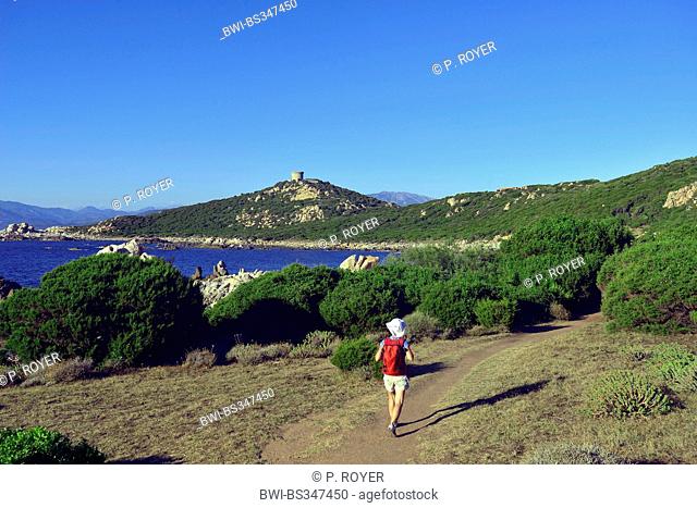 wanderer on path near the coast, Genoese tower in background, France, Corsica, Campomoro, Propriano