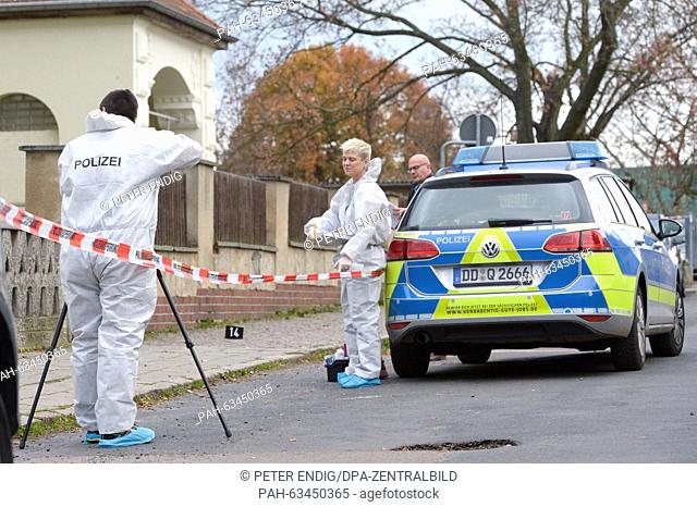 Criminal investigators secure evidence in front of a school in Leipzig, Germany, 10 November 2015. A girl attacked a fellow pupil with a knife