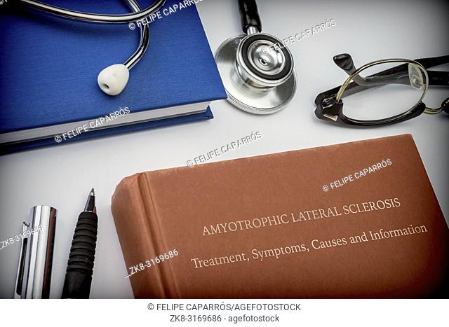 Titled book Amyotrophic Lateral Sclerosis along with medical equipment, conceptual image