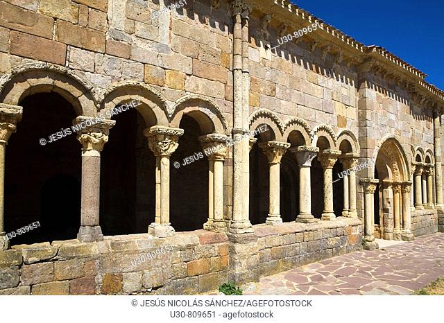 Gallery porched with capitals and columns carved with bas of the romanesque church porticoed of San Juan y Santa Basílica; in Rebolledo de la Torre