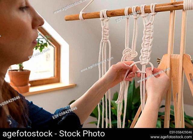 Women making macrame in a beautiful sunny day in attic. Stay at home hobbies