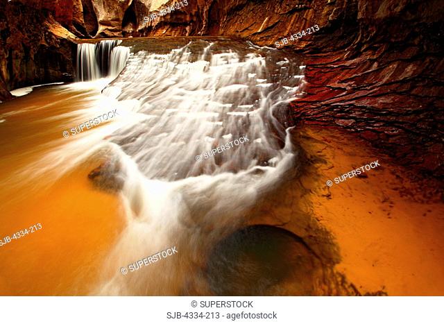 A waterfall in The Subway, a circular slot canyon on the Left Fork of North Creek, in Zion National Park, Utah