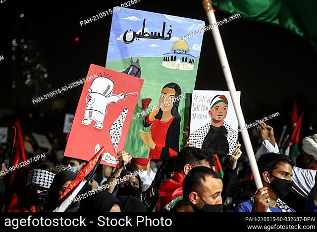 15 May 2021, Qatar, Doha: Participant hold signs during a rally in solidarity with Palestinians outside Doha's Imam Muhammad Abdel-Wahhab Mosque
