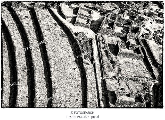 Pisac ruins: detail monochrome view of agricultural terracing and Inca citadel, Sacred Valley, Cuzco, Peru