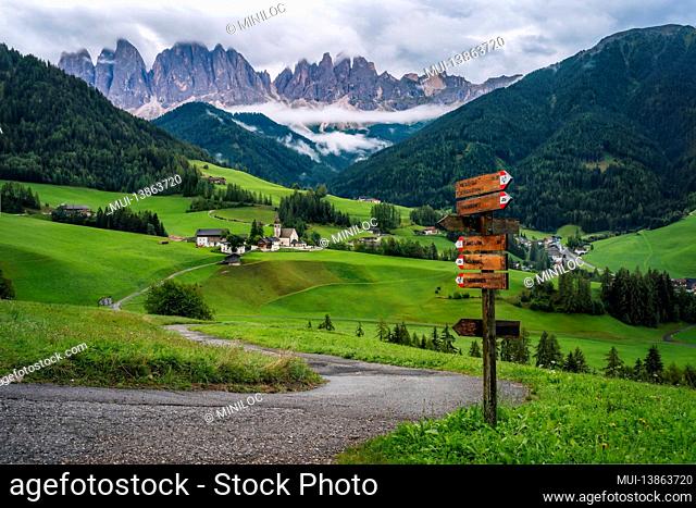 St Magdalena church in Val di Funes valley, Dolomites, Italy. Furchetta and Sass Rigais mountain peaks in background