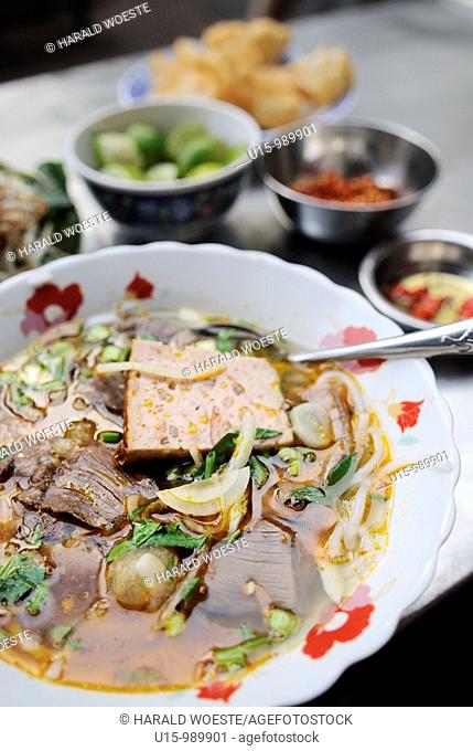 Traditional noodle soup with a slice of beef served as delicious street food ('pho bo'), Ho Chi Minh City, Vietnam