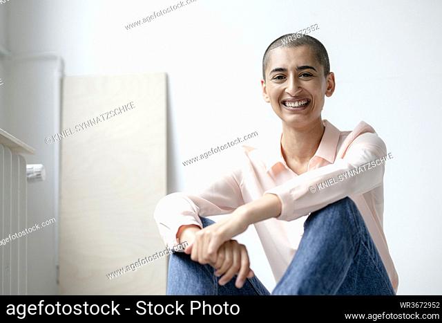 Portrait of a happy woman in a loft