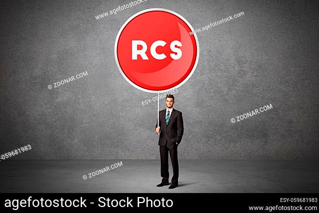 Young business person holdig traffic sign with RCS abbreviation, technology solution concept