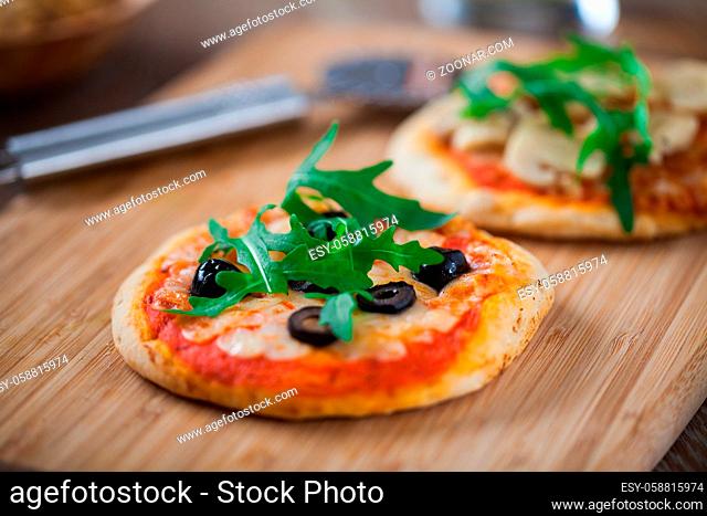 Mini Pizzas served on Wooden Board. High quality photo