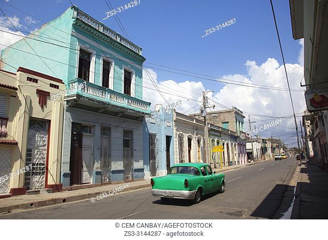 Old American car used as taxi in front of the colonial buildings in the city center, Cienfuegos, Cienfuegos Province, Cuba, Central America