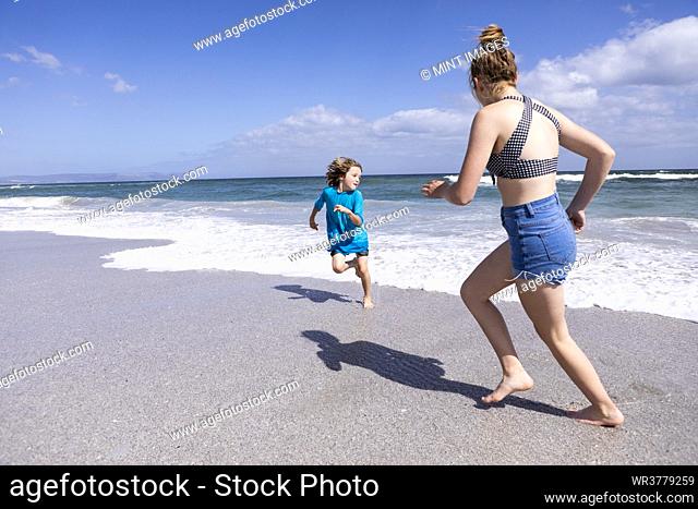 Children playing in surf, Grotto Beach, Hermanus, Western Cape, South Africa