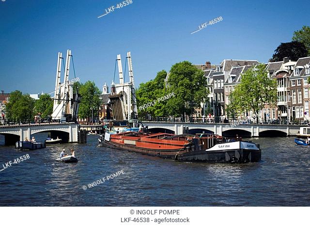 Barge, Magere Brug, Amstel, Barge passing open Magere Brug Skinny Bridge, Amsterdam, Holland, Netherlands