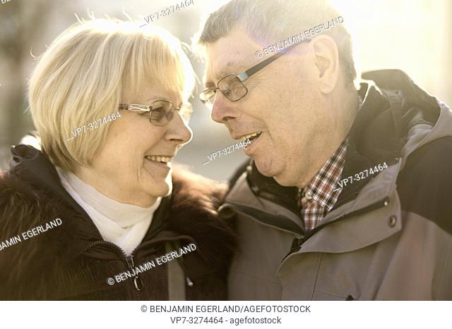 senior couple in sunlight looking at each other, in Cottbus, Brandenburg, Germany