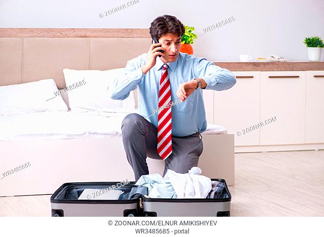 Young handsome businessman preparing for trip