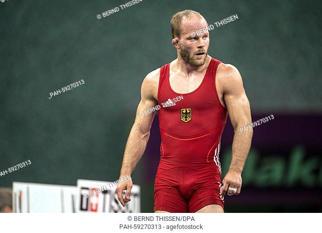 Germany's Marcel Ewald (red) reacts during the wrestling Men's 57kg Freestyle Final against Lebedev (blue) of Russia in the at the Baku 2015 European Games in...