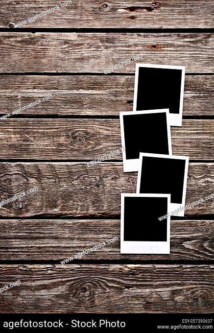 Blank photo frames on old wooden background