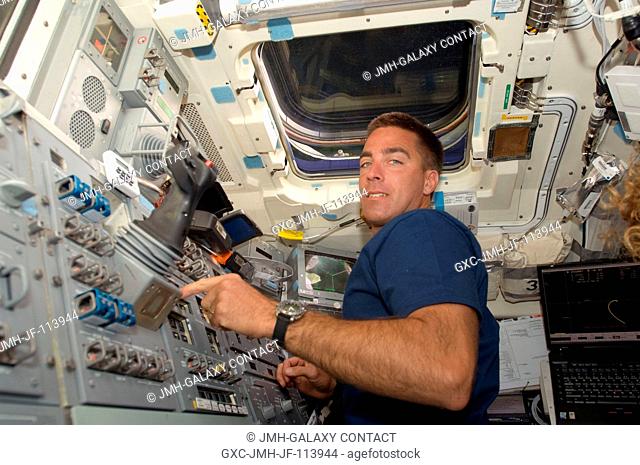 Astronaut Christopher Cassidy, STS-127 mission specialist, is at the controls on the aft flight deck of the Space Shuttle Endeavour during rendezvous and...
