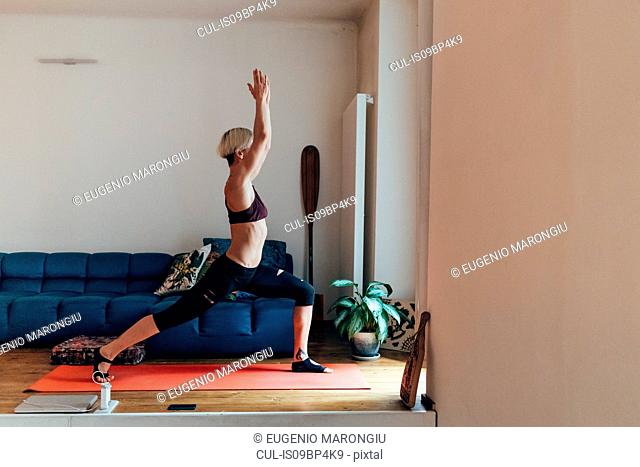 Woman practising yoga at home
