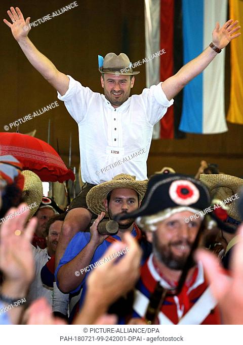 21 July 2018, Germany, Memmingen: Juergen Ziegler being carried into the Stadium Hall. Ziegler is the 2018 'Fisher King'