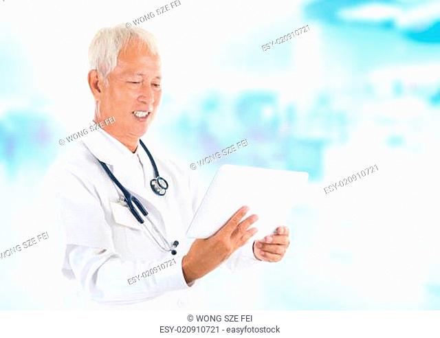 Asian senior doctor using tablet-pc