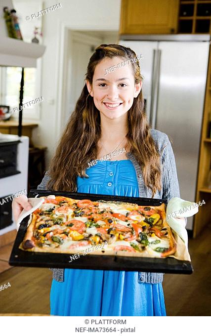 Girl with a homemade pizza, Sweden