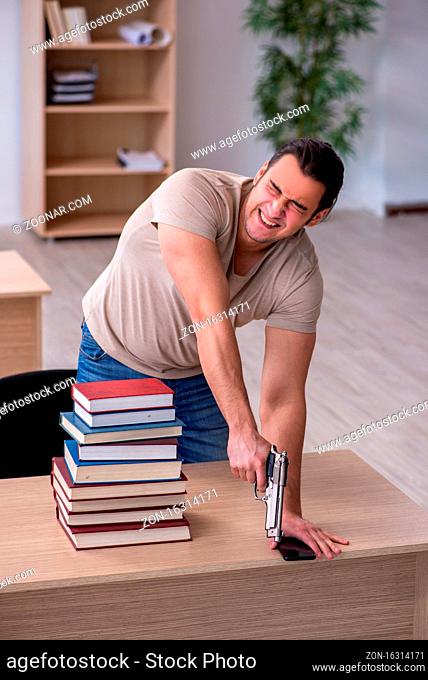 Male student preparing for exams at library