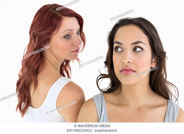 Unhappy young female friends not talking after argument