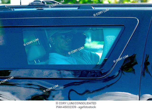United States President Barack Obama rides in his armored SUV on his way out of Kailuana Street in Kailua, Hawaii on his way to golf at the Marine Corps Base...