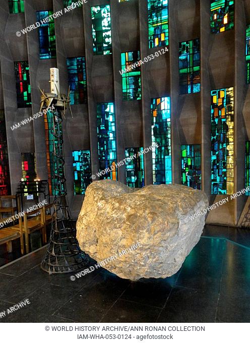 Boulder from Bethlehem and stained glass windows designed by john Piper depict the light of god, at the New St Michael's Cathedral, Coventry