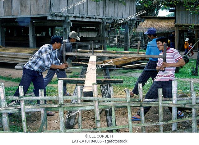 Men working. Sawing planks of wood with long saws, by hand
