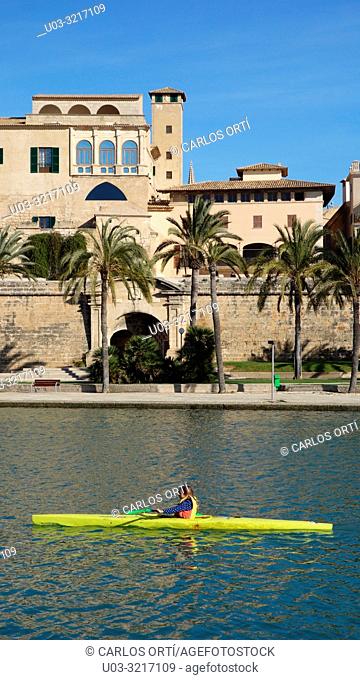 Canoeist in a kayak in front of the Archiepiscopal Palace in Palma de Majorca, The Balaric capital city. Spain, Europe