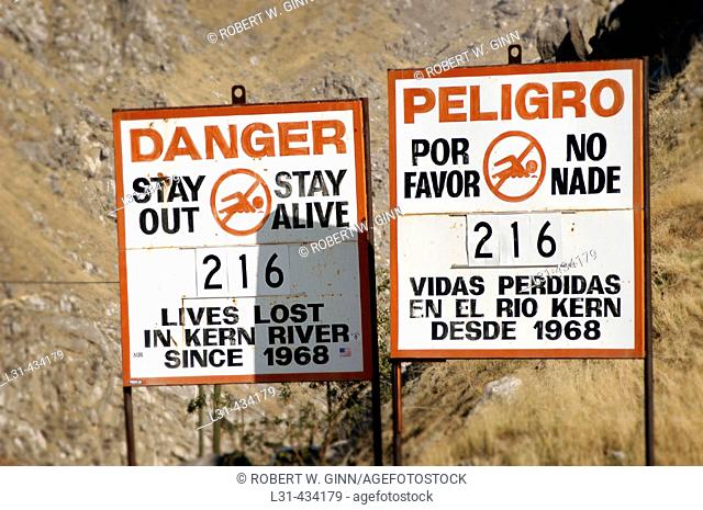 Killer Kern River sign showing death count in Spanish and English in California at mouth of canyon