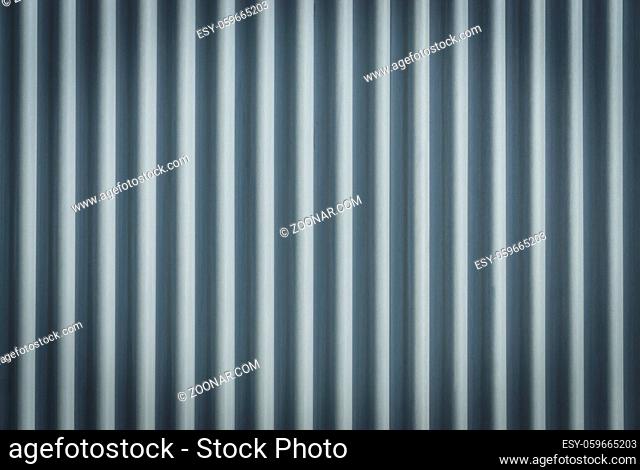 Closeup stainless steel corrugated sheet. Ridged reinforced metal surface for protection. Metallic background texture
