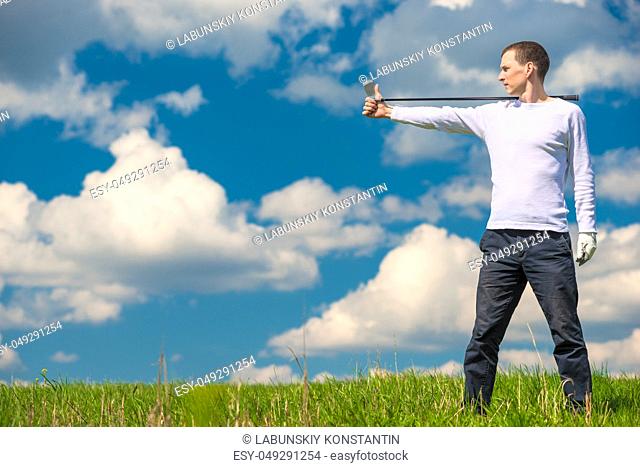 golfer in the field with a stick for playing golf on the right, on the left is a stretch for the inscription