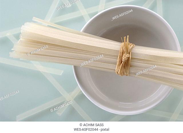 Rice noodles on bowl, overhead view, close-up