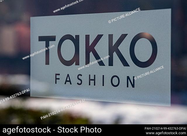 12 February 2021, North Rhine-Westphalia, Telgte: The Takko logo of a Takko Fashion store in Telgte is stuck on a pane of glass