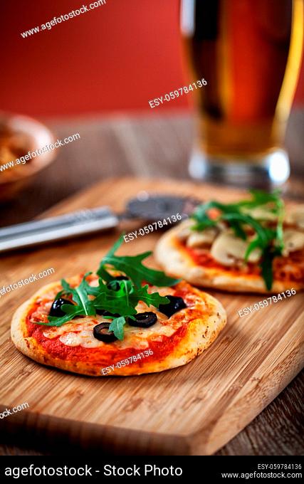 Mini Pizzas served on Wooden Board. High quality photo