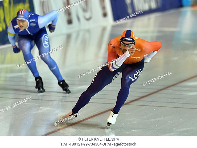 Speed skater Kjeld Nuis (Netherlands) on his way to his victory while Norway's second-placed Havard Holmefjord Lorentzen can be seen in the background at the...