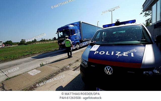 A policeman stops a truck during a search for smugglers at the Austrian-Hungarian border in Nickelsdorf, Austria, 1 September 2015