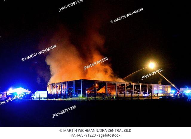 Firefighters battle flames at a warehouse in Hoersel, Germany, 12 February 2016. The fire ignited in the warehouse of plastics manufacturer in the early morning...