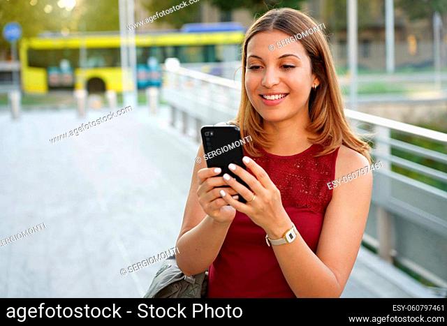 Attractive girl using phone outdoors
