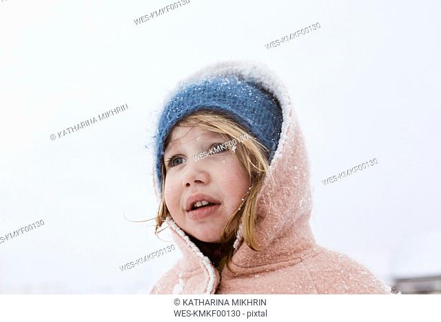 Portrait of little girl in snowfall