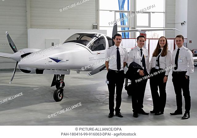 16 April 2018, Germany, Laage: Four student pilots standing beside one of the aircrafts during the ceremonious commissioning of the five new Diamond DA-42...