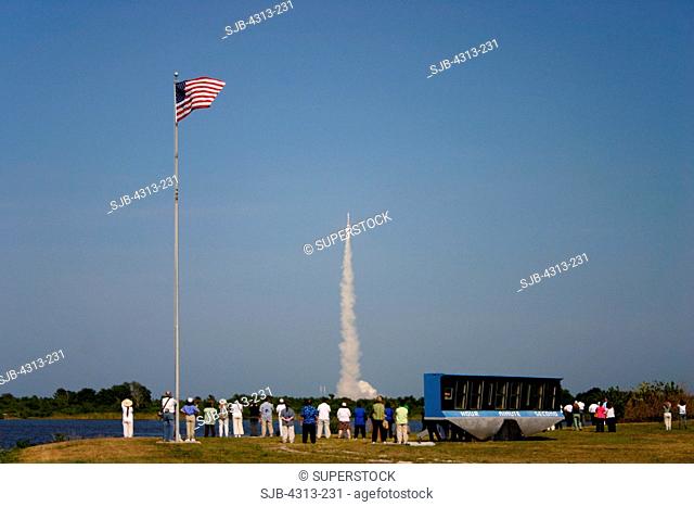 Spectators watch an Atlas V rocket launching the ASTRA 1KR communications satellite