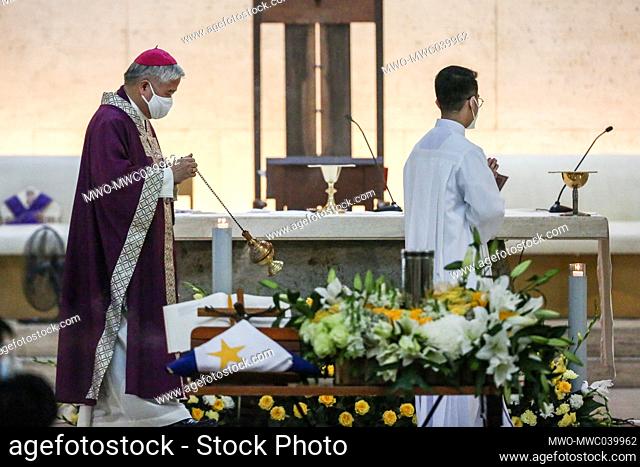 Catholic Archbishop Socrates Villegas scatter incense smoke prays over the urn of former Philippine President Benigno Aquino III during a mass at Church of Gesu